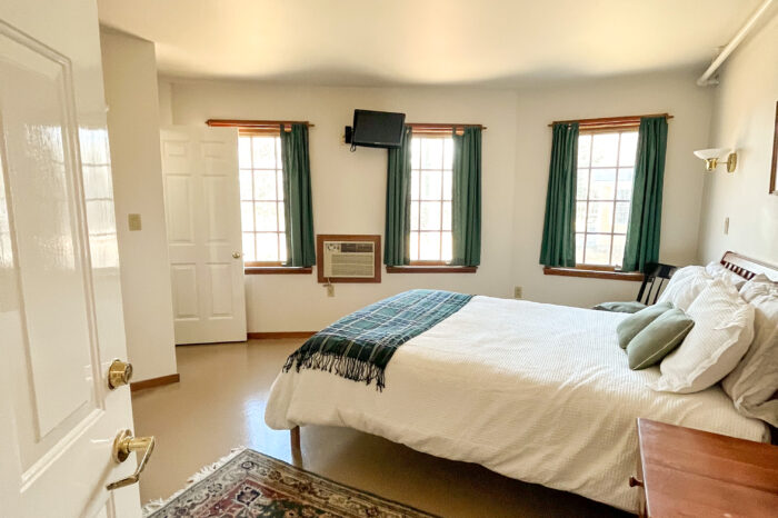 A cozy 2nd-floor Unit #8 with a queen bed and private bath with shower